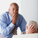 Businessman helping stressed colleague